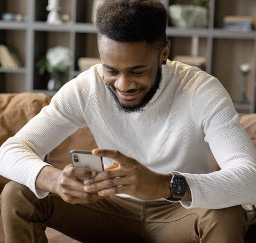 image with a man writing a text on his cell phone